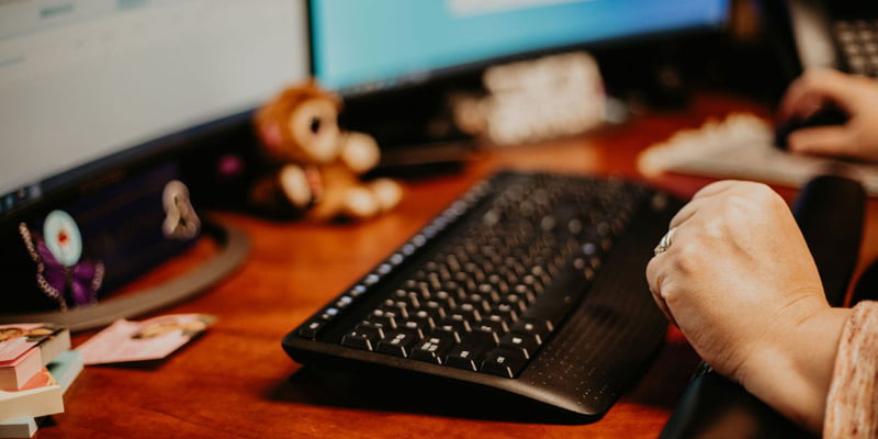 Close up of Nomad employee hands on keyboard at desk